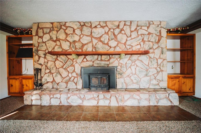 unfurnished living room featuring a wood stove and a textured ceiling