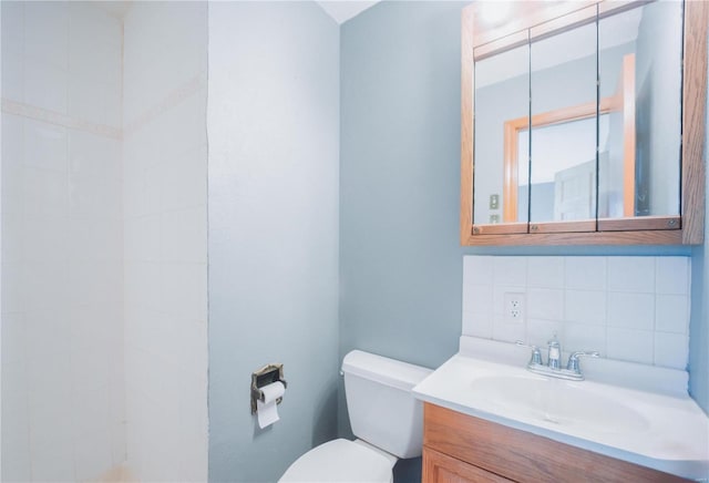 bathroom with tasteful backsplash, vanity, and toilet