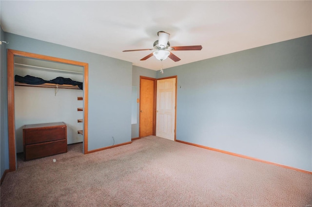 unfurnished bedroom featuring ceiling fan, a closet, and carpet