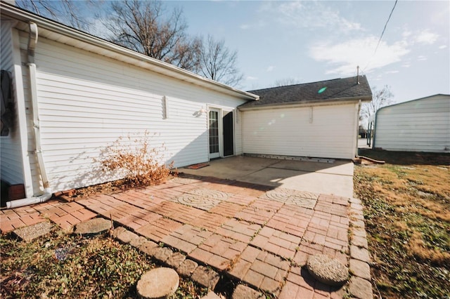 back of property with a patio and an outdoor structure