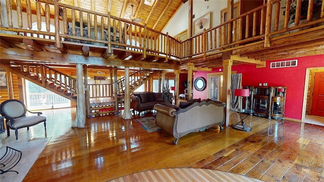 living room featuring wood ceiling, beam ceiling, hardwood / wood-style flooring, high vaulted ceiling, and decorative columns