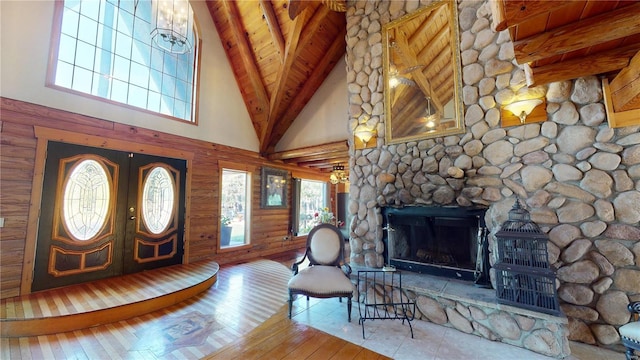 foyer entrance featuring high vaulted ceiling, wooden ceiling, wood-type flooring, beamed ceiling, and french doors