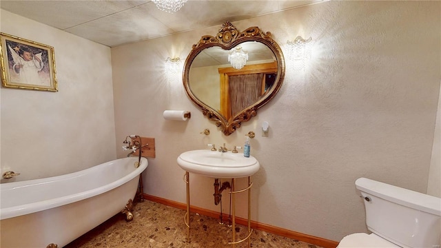 bathroom featuring a bath, toilet, and sink