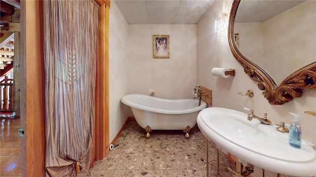 bathroom with sink and a washtub