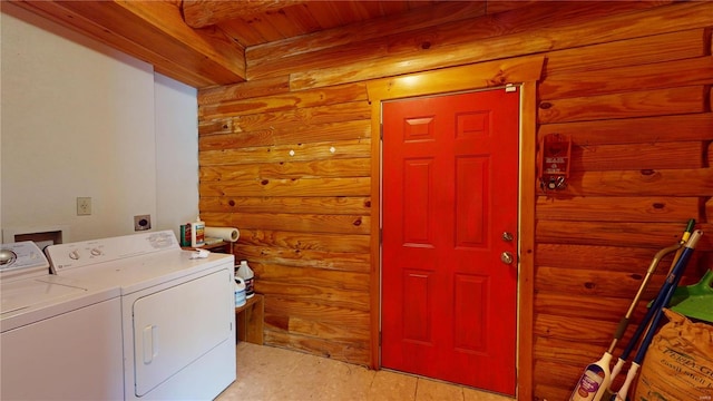 laundry area featuring wooden ceiling, log walls, and washing machine and clothes dryer