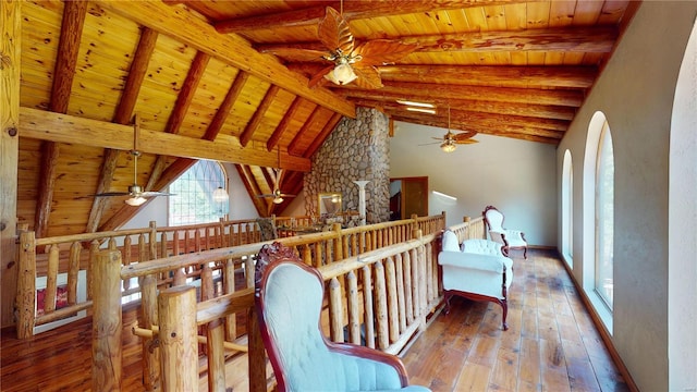 interior space with hardwood / wood-style floors, lofted ceiling with beams, wooden ceiling, and ceiling fan