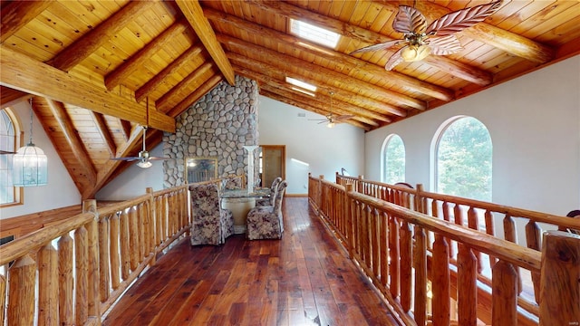 hallway featuring beamed ceiling, dark wood-type flooring, and wooden ceiling