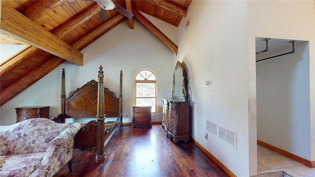 bedroom with high vaulted ceiling, beam ceiling, hardwood / wood-style flooring, and wooden ceiling