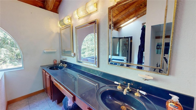 bathroom with vanity, lofted ceiling with beams, and tile patterned floors