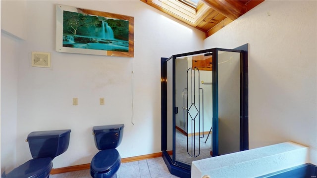 interior space featuring vaulted ceiling with skylight, light tile patterned floors, and wooden ceiling