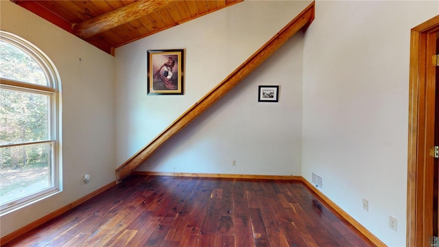 interior space featuring wood ceiling, dark hardwood / wood-style flooring, and vaulted ceiling with beams