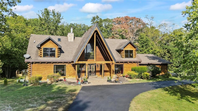 cabin with a front lawn