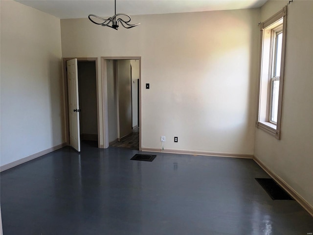 spare room featuring dark wood-type flooring and a healthy amount of sunlight