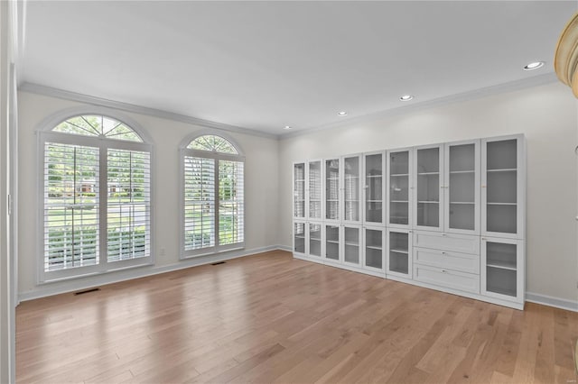 unfurnished room featuring light hardwood / wood-style flooring and ornamental molding