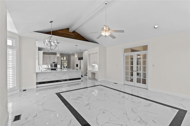 unfurnished living room featuring light tile patterned floors, ceiling fan with notable chandelier, plenty of natural light, and beam ceiling