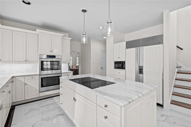 kitchen with a kitchen island, white cabinets, light tile patterned floors, and black appliances