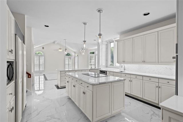 kitchen featuring lofted ceiling, pendant lighting, light tile patterned floors, a kitchen island, and ceiling fan