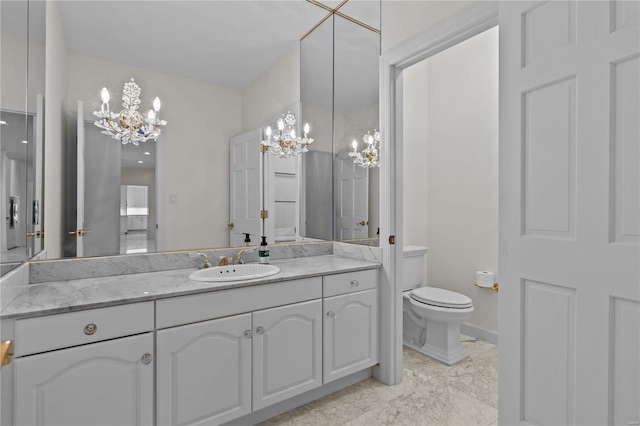 bathroom with tile patterned flooring, a notable chandelier, toilet, and vanity