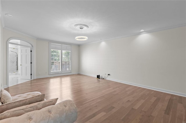 living room featuring hardwood / wood-style flooring and crown molding