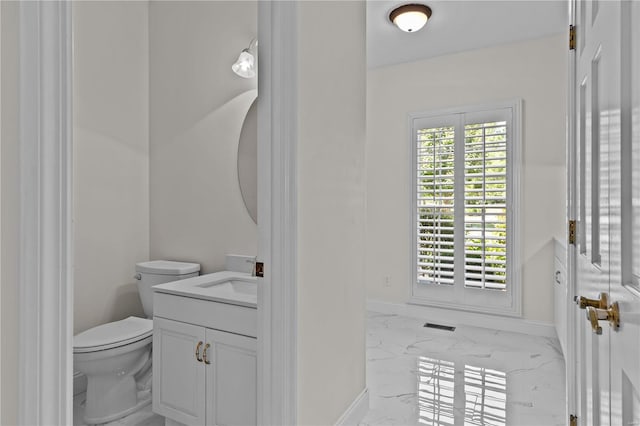 bathroom featuring toilet, vanity, and tile patterned floors