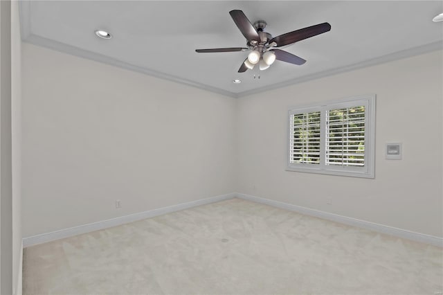 unfurnished room featuring ceiling fan, light carpet, and ornamental molding