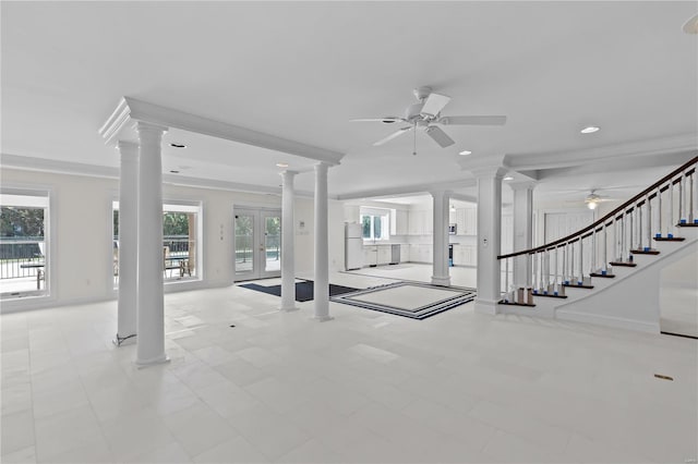 unfurnished living room with ceiling fan, ornate columns, ornamental molding, and light tile patterned floors