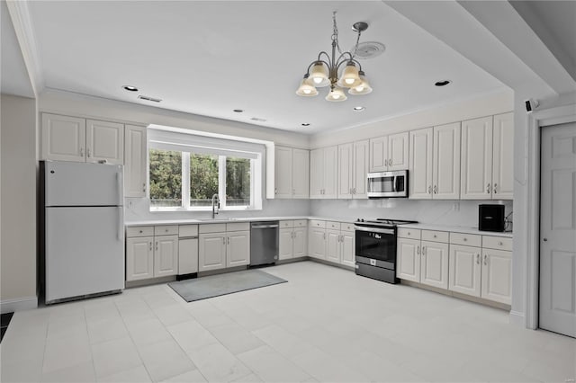 kitchen featuring sink, white cabinetry, appliances with stainless steel finishes, light tile patterned floors, and hanging light fixtures