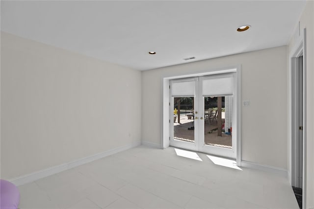 spare room with light tile patterned floors and french doors