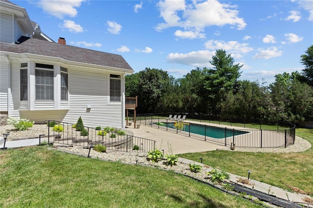 view of pool with a yard