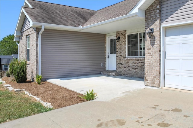 view of exterior entry featuring a garage