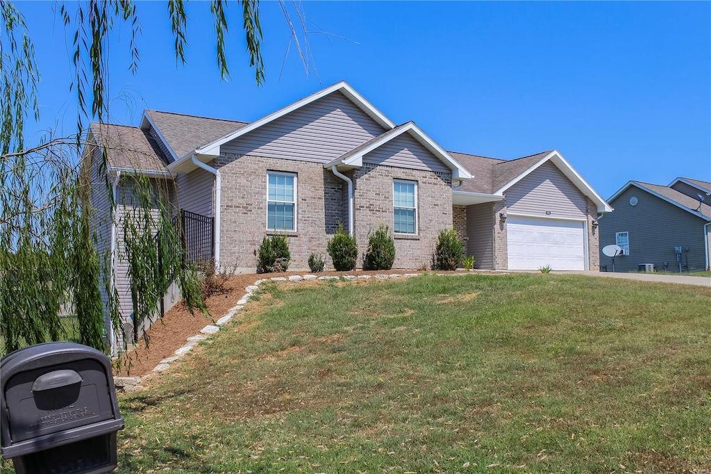 ranch-style home with a garage and a front yard