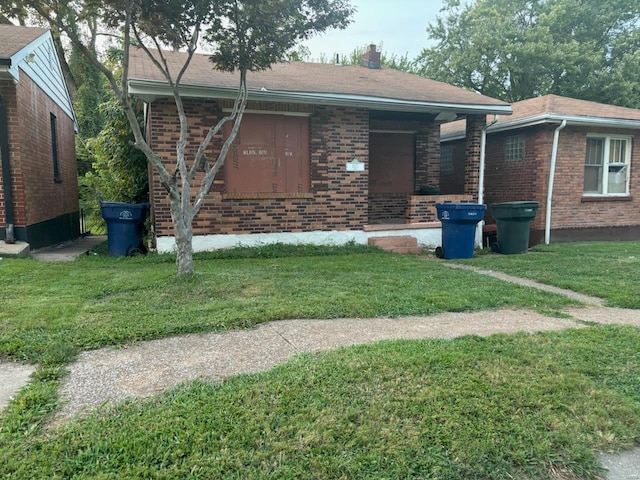 ranch-style home with a front lawn