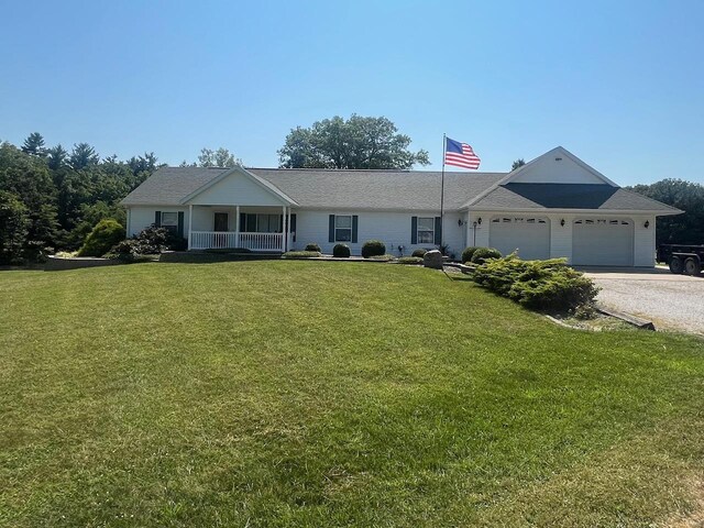 ranch-style home featuring a garage and a front lawn