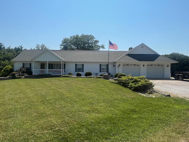 ranch-style home with a front lawn, a garage, and covered porch