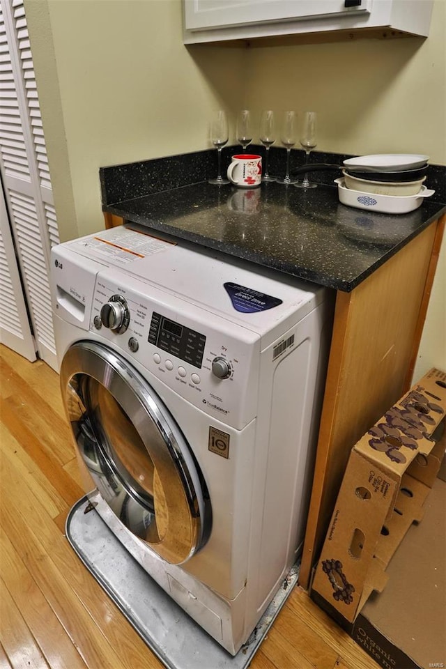 laundry room with washer / clothes dryer and light hardwood / wood-style floors