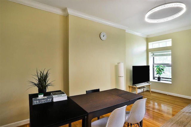 office area with crown molding and light wood-type flooring