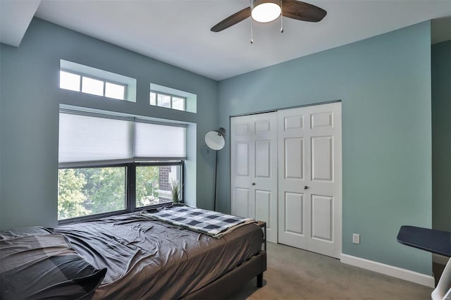 carpeted bedroom featuring a closet and ceiling fan