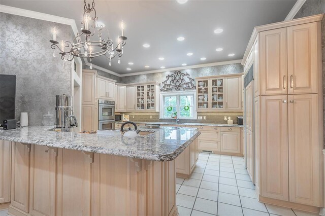 kitchen featuring a kitchen bar, tasteful backsplash, ornamental molding, and light stone countertops