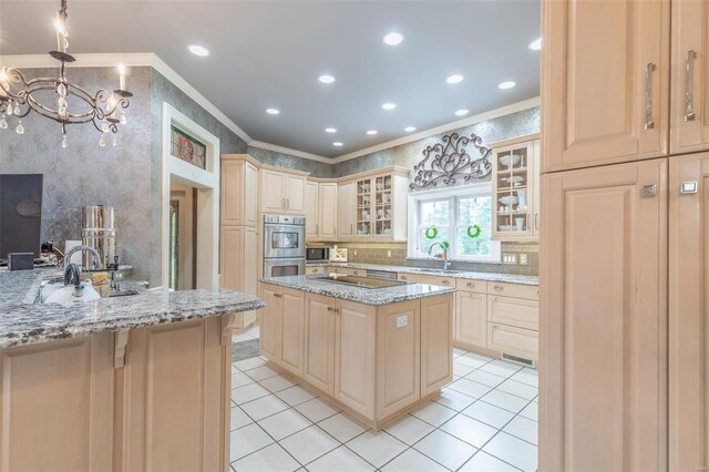 kitchen with light stone countertops, ornamental molding, and a kitchen island