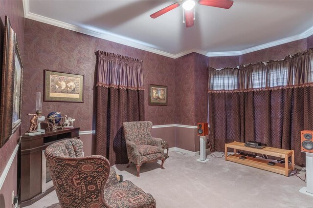 sitting room featuring ceiling fan, light carpet, and ornamental molding