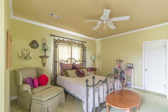 carpeted bedroom featuring ceiling fan and ornamental molding