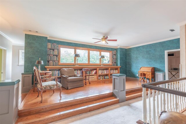 living room with ceiling fan, light hardwood / wood-style floors, and ornamental molding