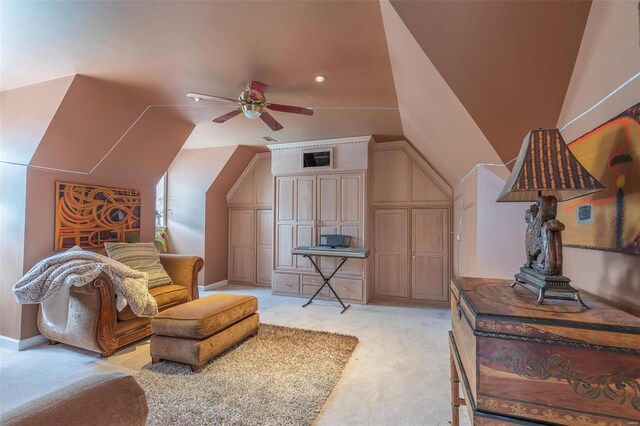 interior space with ceiling fan, vaulted ceiling, and light colored carpet