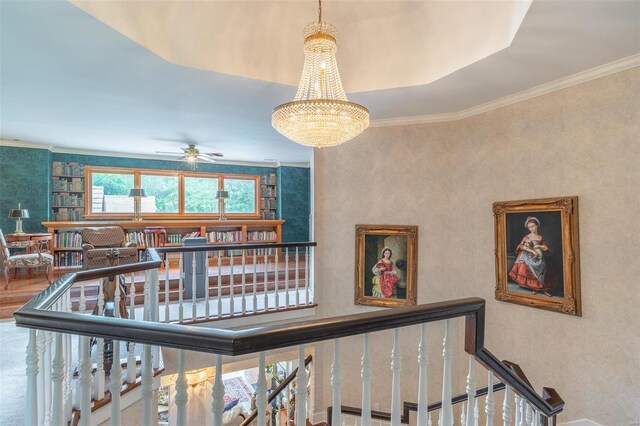 staircase with ceiling fan with notable chandelier and crown molding