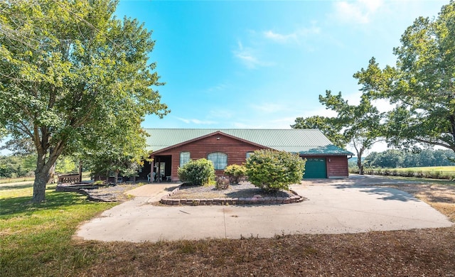 view of front of property with a garage and a front yard