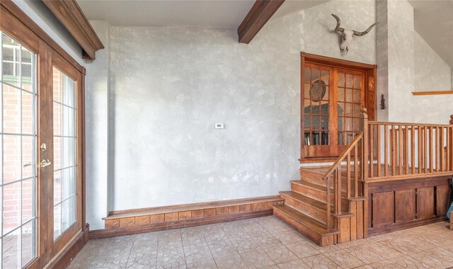 stairway featuring lofted ceiling with beams, french doors, and tile patterned flooring