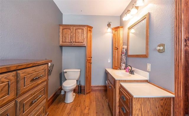 bathroom featuring hardwood / wood-style floors, toilet, and vanity