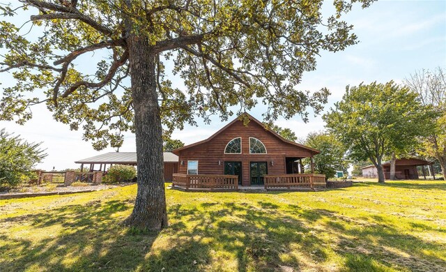 back of property featuring a gazebo and a lawn