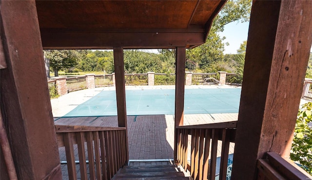 exterior space with a covered pool and a patio