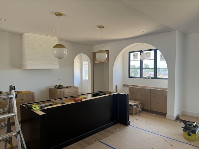 interior space with light hardwood / wood-style flooring and decorative light fixtures